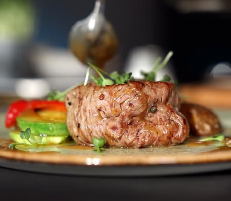 Beef steak with grilled vegetables served on white plate